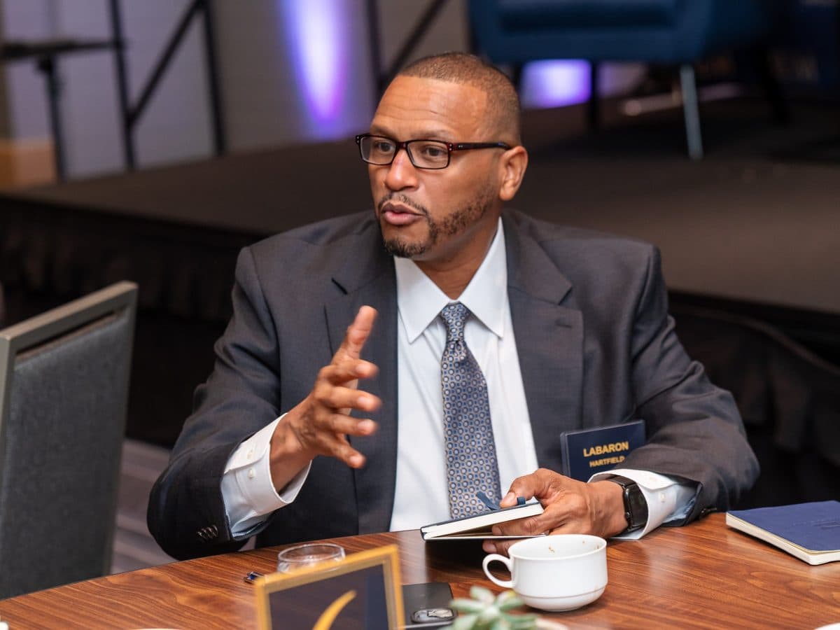 A member making a point at a small BEM table