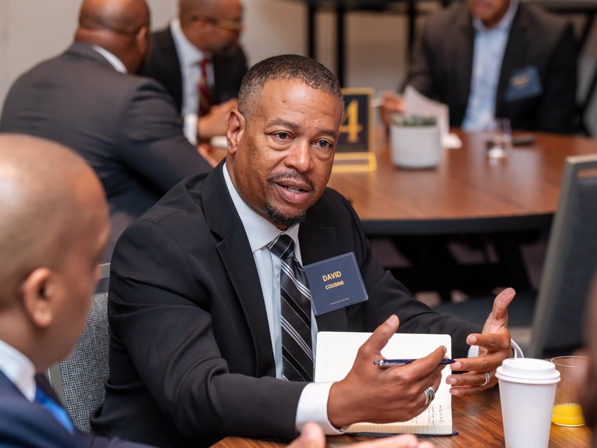 David Cousins speaking with members at a BEM forum table